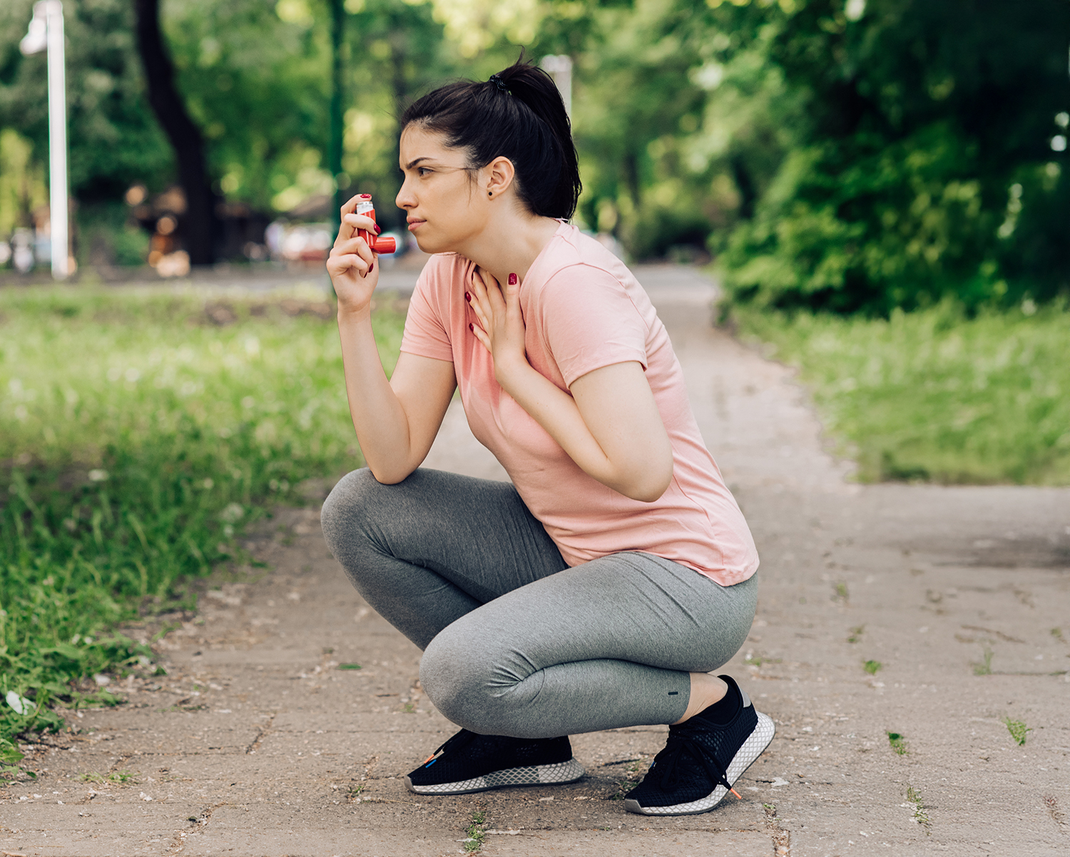 Girl using asthma inhaler